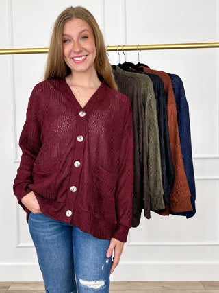 Wine red knit long-sleeve button-up cardigan with V-neck and front patch pockets