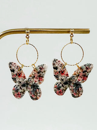 Gold drop earrings with circular hoop and floral butterfly clay charms