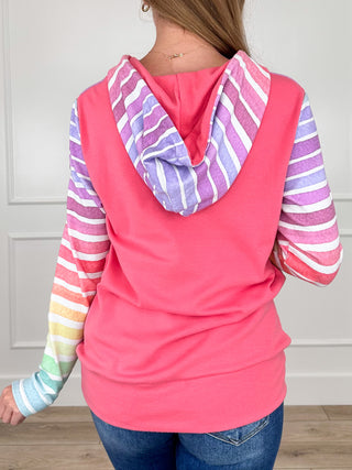 Pink hooded half-zip sweatshirt with multicolor striped sleeves and back hood drape