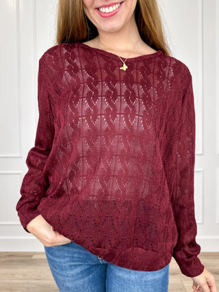 Wine red knit long-sleeve top with textured pattern and rounded neckline