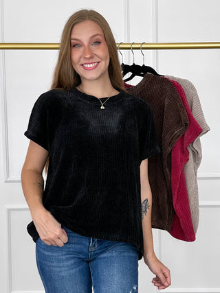 Black knit short-sleeve top with crew neckline and relaxed fit