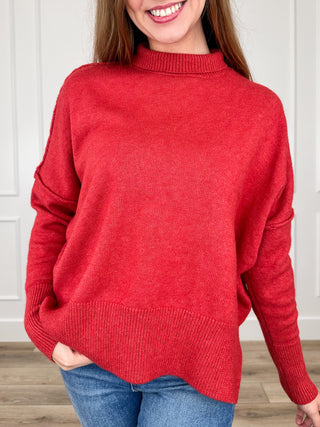 Red knit long-sleeve sweater with crew neck and ribbed hem, relaxed fit