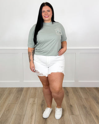 Mint green T-shirt and white distressed denim shorts