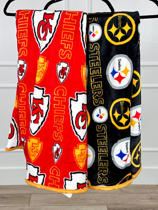 Plush blanket set with red Kansas City Chiefs and black Pittsburgh Steelers designs