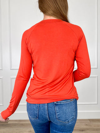 Orange long-sleeve crewneck rayon-blend top back view with gathered waist hem