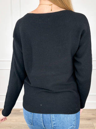 Black ribbed long-sleeve crewneck top, back view with waist seam