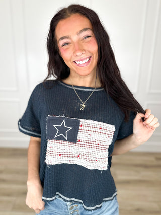 Navy knit cropped top, short sleeves, star-and-flag front patch