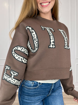 Brown cropped crewneck sweatshirt with bold leopard-print letter graphic and long sleeves