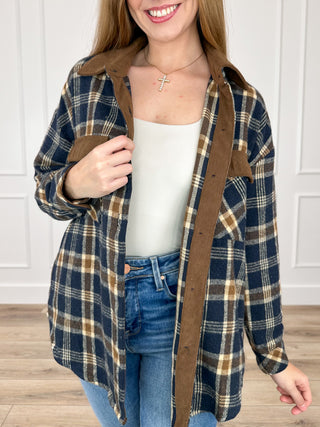 Navy and tan plaid flannel shacket with long sleeves, button front, collared
