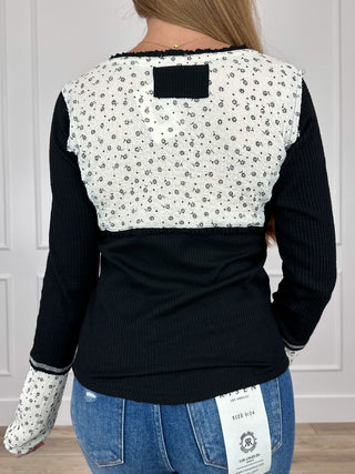 Two-tone knit long-sleeve top, speckled upper back with square neck patch, black hem