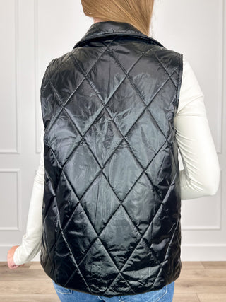 Black hooded puffer vest with diamond quilted back and relaxed fit