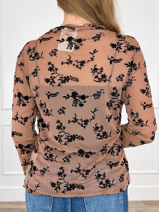 Tan sheer mesh long-sleeve top with black floral print, back view