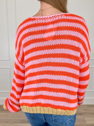 Cropped striped knit sweater top, back view, red and white stripes, tan ribbed hem