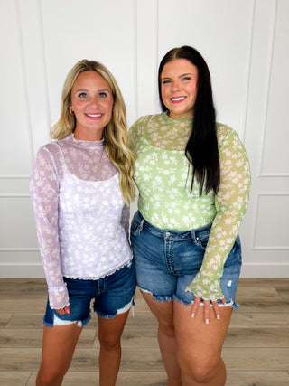 Sheer mesh long-sleeve floral top, purple and green with mock neckline.