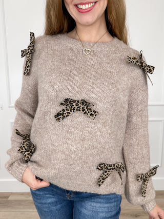 Taupe knit long-sleeve sweater with leopard print bow details at cuffs and hem