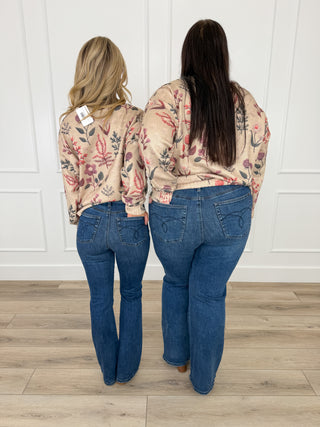 Dark blue bootcut jeans with tummy control, back pockets visible, non-distressed wash