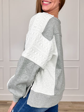 Two-tone long sleeve top in gray and white with lace-texture sleeves, relaxed fit