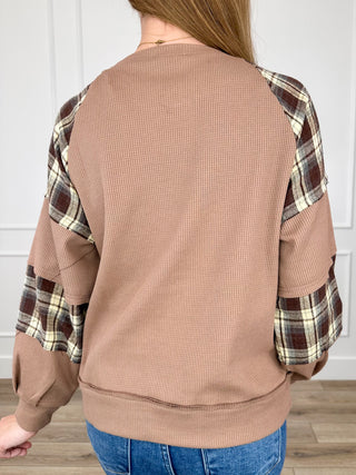 Brown knit long sleeve top with plaid sleeve panels, back view, crew neckline.