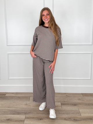 Brown and white striped short-sleeve top with crew neckline, worn with matching pants