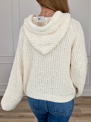 Cream hooded knit sweater top, back view with hood and ribbed cuffs
