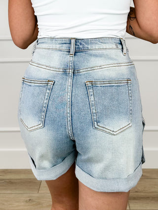 Light wash denim high-rise shorts with back pockets and stud-trim detail.