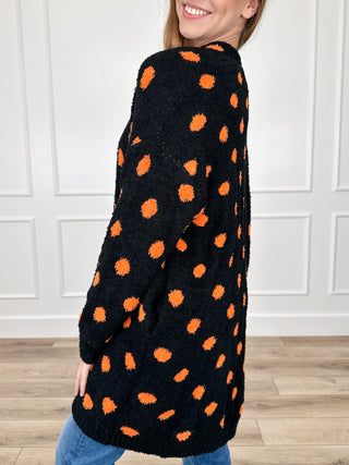 Reversible long-sleeve knit cardigan, black with orange dot pattern, side view