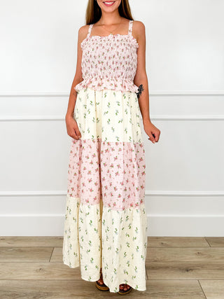 Pink and cream tiered maxi dress with ruffled neckline and spaghetti straps