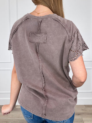 Brown cotton short-sleeve top with cross-shaped back applique and lace cutout sleeves