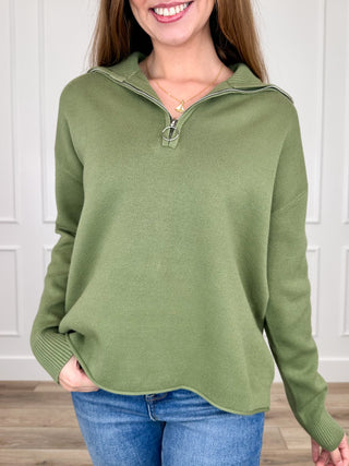 Green half-zip knit sweater top with long sleeves and ribbed collar
