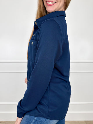 Blue ribbed long-sleeve button-up top, side view with buttoned placket and sleeves