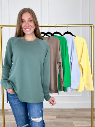 Forest green ribbed long-sleeve crew neck top on model