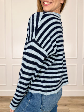 Long-sleeve knit cardigan back view, blue-and-white striped with ribbed hem