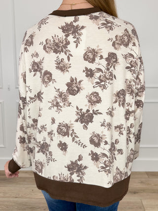 Cream knit long-sleeve top, full back dark floral print with brown neckline band