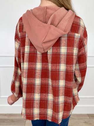 Back of hooded flannel button-up shacket in brick red plaid with drawstring hood
