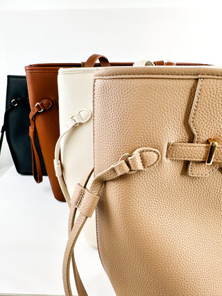 Faux leather tote bag set showing tan, white, and brown bags with front straps and buckles