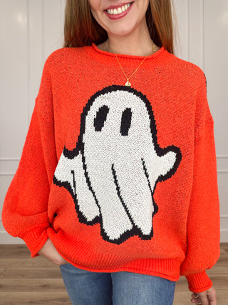 Orange knit long-sleeve sweater with ghost character graphic on crewneck