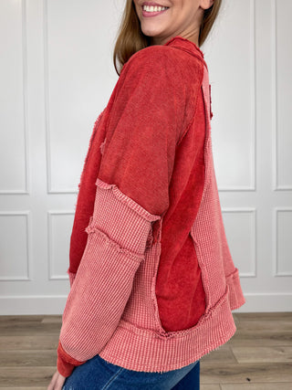 Brick red hooded long-sleeve cotton top with patchwork sleeves and ribbed cuffs