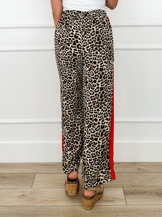 Leopard print high-rise pants with red side trim and straight legs