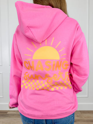 Pink hoodie with large back sun and text graphic, oversized hood, long sleeves