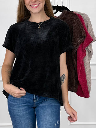 Black knit short-sleeve top with crew neckline and loose drape