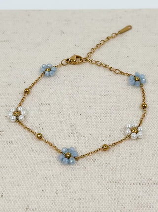 Gold-tone chain bracelet with blue flower and white pearl beads, lobster clasp