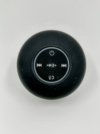 Dark round Bluetooth speaker with top control icons and power button
