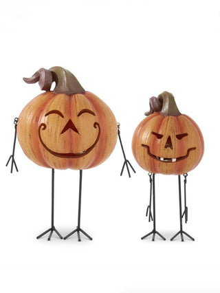 Resin jack-o'-lantern decor with carved smile face, on black tripod legs