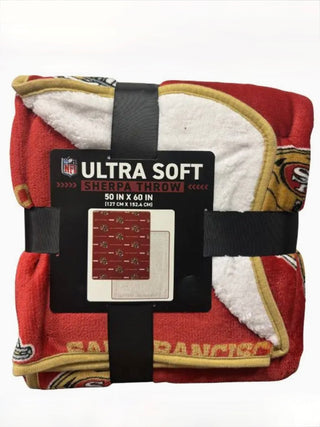 Sherpa throw blanket, red with NFL Ultra Soft Sherpa Throw label and black straps