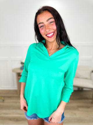 Lightweight 3/4 sleeve V-neck top in green, worn with denim shorts.