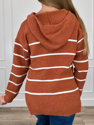 Rust orange striped knit hooded sweater with draped hood and long sleeves