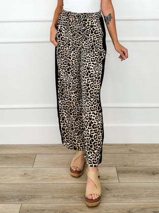 Leopard print high-rise pants with red side trim, relaxed fit