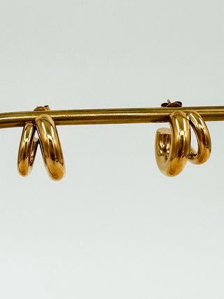 Gold double-hoop earrings with curved dangling inner ring