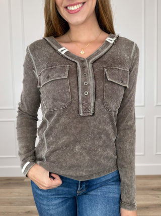 Brown long-sleeve henley top with henley buttons and two chest pockets