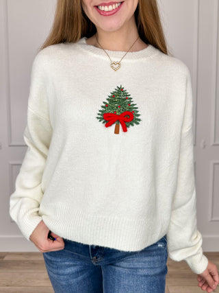 Ivory knit long-sleeve sweater top with embroidered Christmas tree and red bow